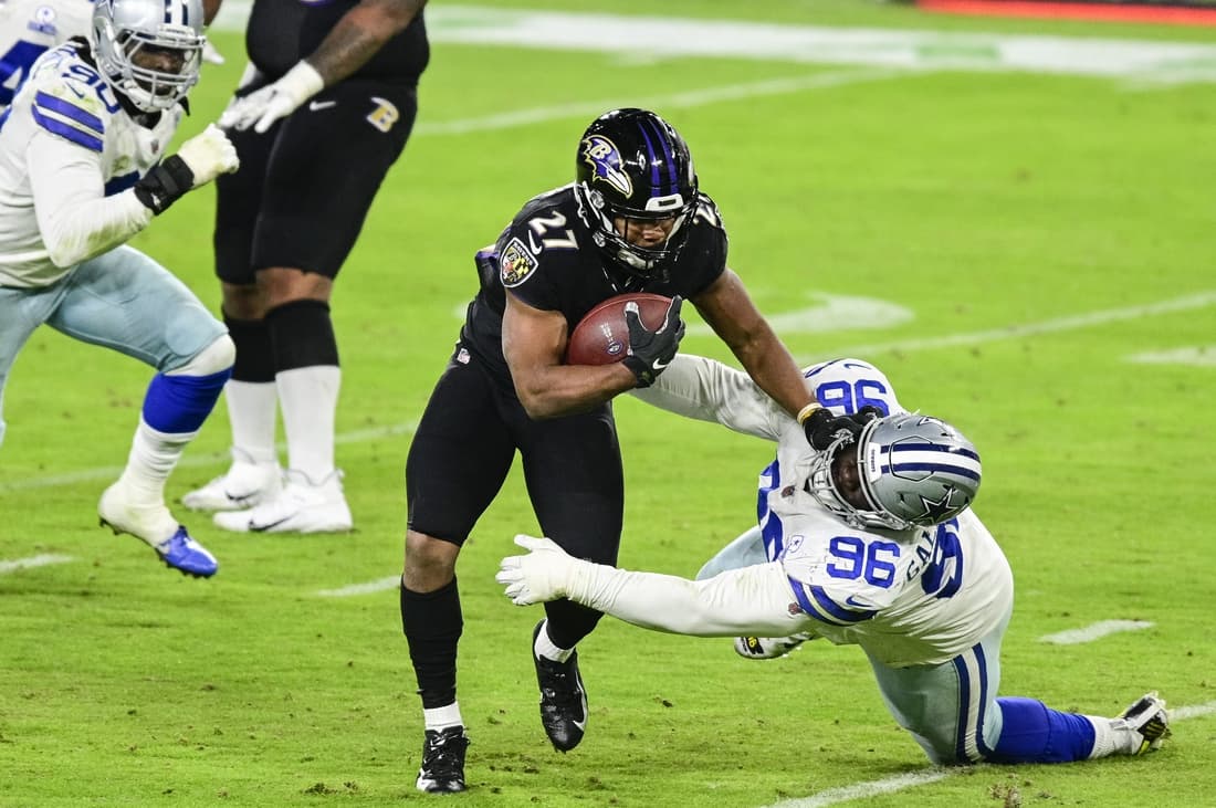 Dec 8, 2020; Baltimore, Maryland, USA; Baltimore Ravens running back J.K. Dobbins (27) stiff arms Dallas Cowboys defensive tackle Neville Gallimore (96) during the second half at M&T Bank Stadium. Mandatory Credit: Tommy Gilligan-USA TODAY Sports