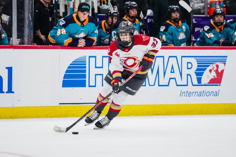 Ottawa Charge forward Rebecca Leslie carries the puck against the New York Sirens.