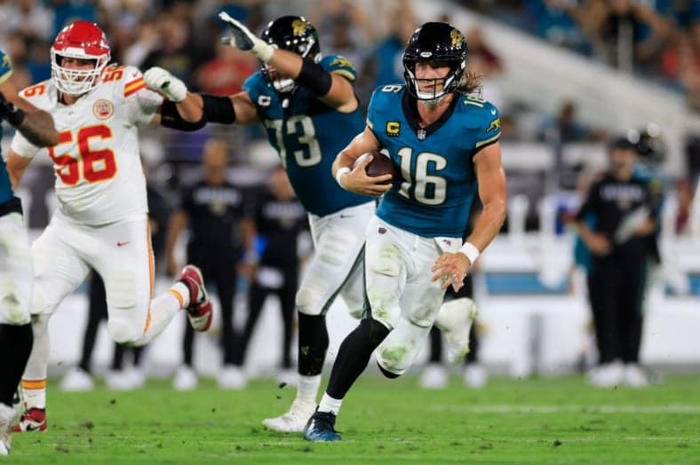 Jacksonville Jaguars quarterback Trevor Lawrence (16) rushes for yards during the second quarter of an NFL football matchup at