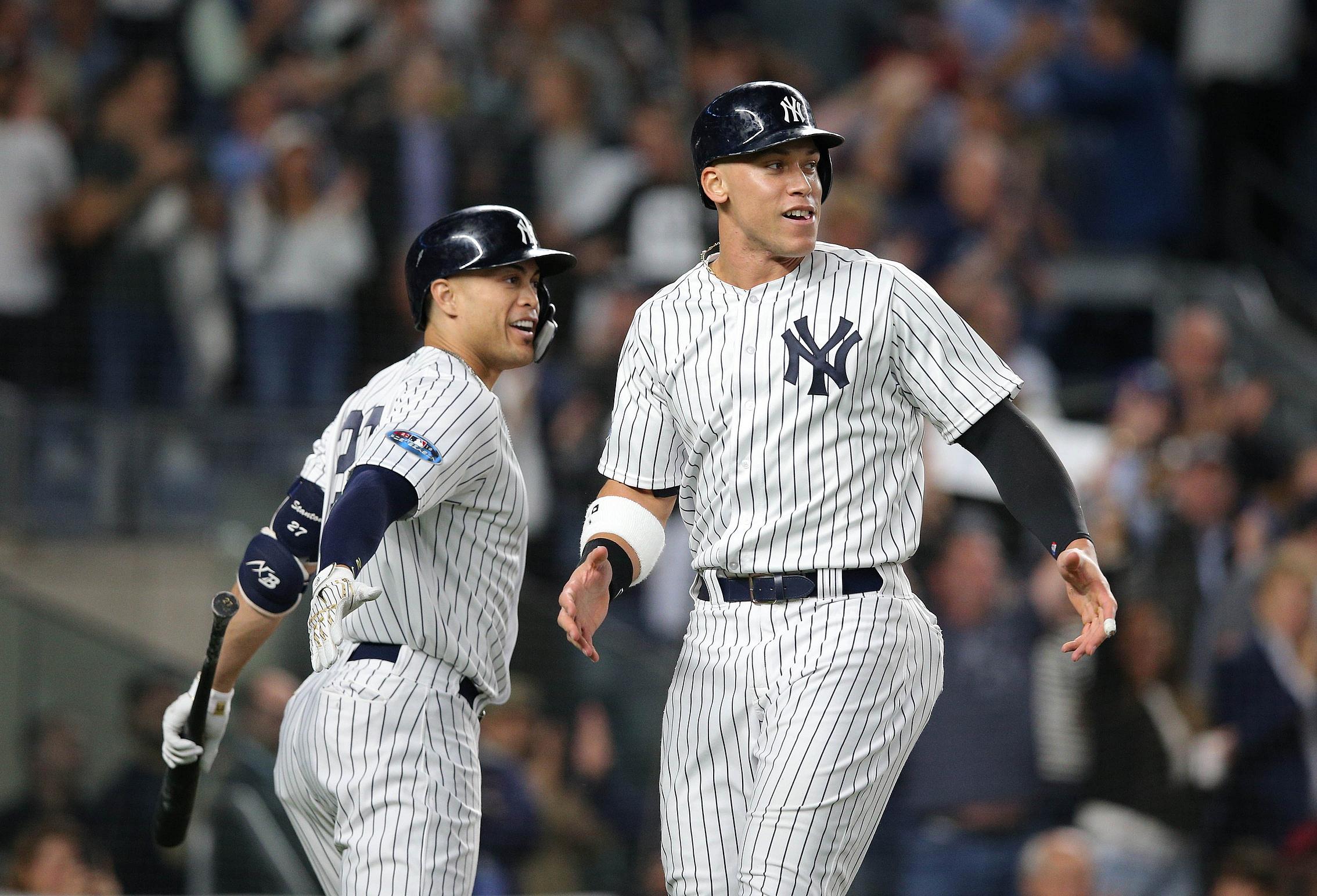 Oct 3, 2018; Bronx, NY, USA; New York Yankees right fielder Aaron Judge (99) and left fielder Giancarlo Stanton (27) celebra…