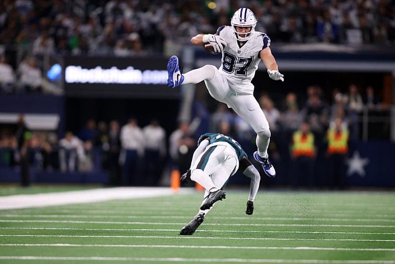 Dec 10, 2023; Arlington, Texas, USA; Dallas Cowboys tight end Jake Ferguson (87) jumps over Philadelphia Eagles cornerback K…