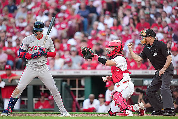 CINCINNATI, OH – MARCH 26:   Home-plate umpire Dan Iassogna calls a strike for Roman Anthony #19 of the Boston Red Sox befor…