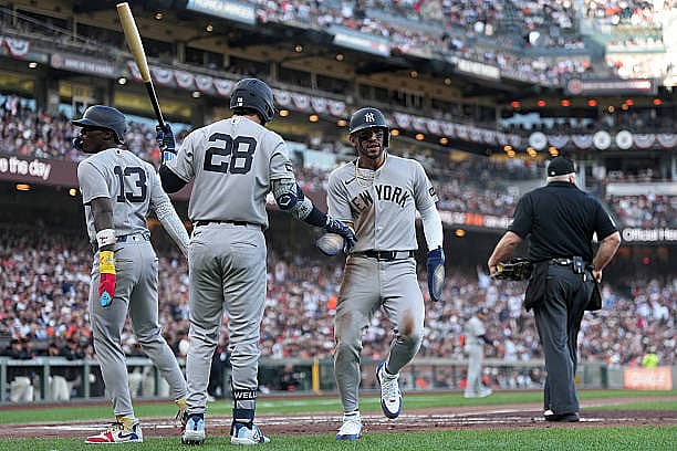 SAN FRANCISCO, CALIFORNIA – MARCH 25: José Caballero #72 of the New York Yankees embraces Austin Wells #28 and Jazz Chisholm…
