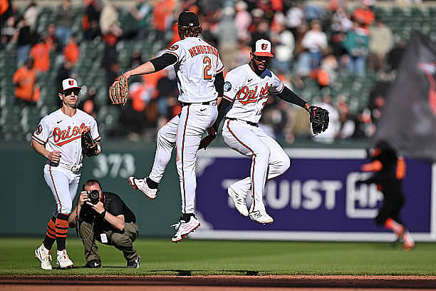 BALTIMORE, MD – MARCH 29:  Gunnar Henderson #2 and Leody Taberas #30 of the Baltimore Orioles celebrate after defeating the…