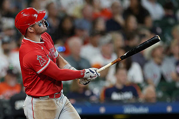 HOUSTON, TEXAS – MARCH 26: Mike Trout #27 of the Los Angeles Angels hits a solo home run in the seventh inning against the H…