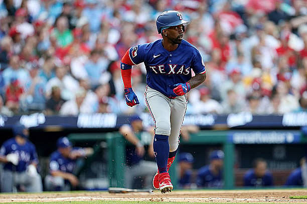 PHILADELPHIA, PENNSYLVANIA – MARCH 26: Andrew McCutchen #4 of the Texas Rangers hits a double in the fourth inning against t…
