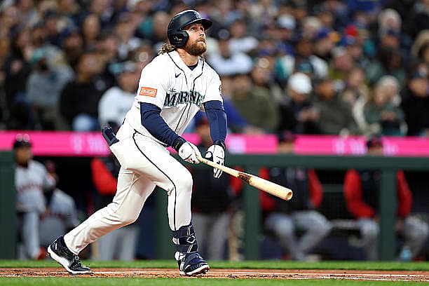 SEATTLE, WASHINGTON – MARCH 26: Brendan Donovan #33 of the Seattle Mariners watches his solo home run during the first innin…