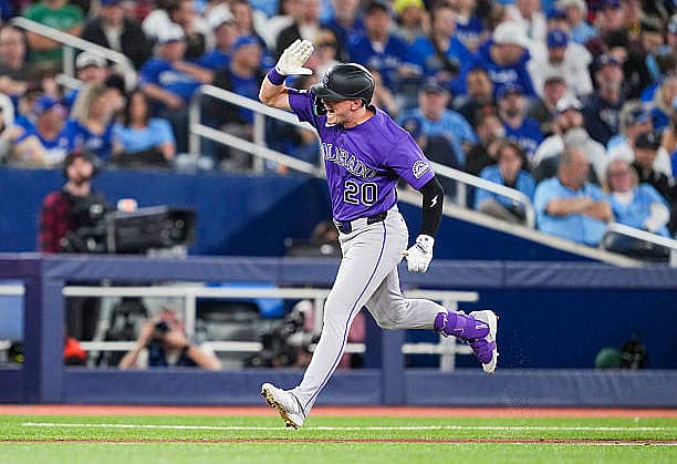 TORONTO, CANADA – MARCH 30: Troy Johnston #20 of the Colorado Rockies celebrates a two run home run against the Toronto Blue…