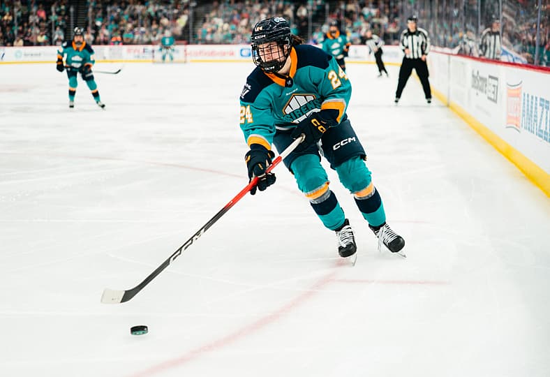 New York Sirens rookie Anne Cherkowski carries the puck against the Minnesota Frost.