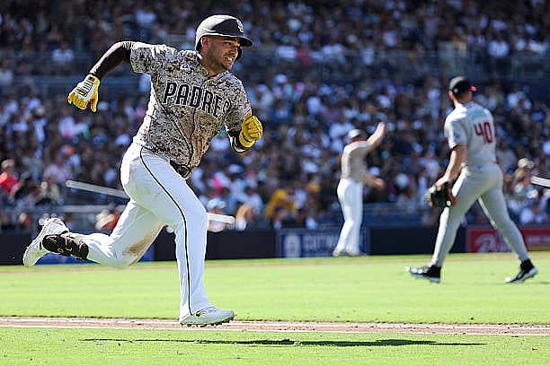SAN DIEGO, CALIFORNIA – SEPTEMBER 28: Jose Iglesias #7 of the San Diego Padres runs after hitting an RBI double against the…