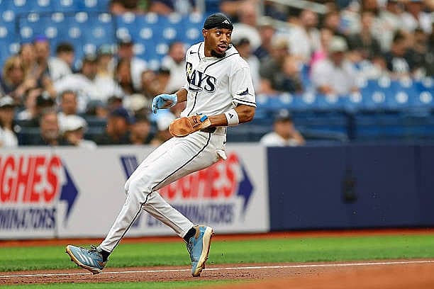 ST. PETERSBURG, FL – APRIL 12: Chandler Simpson #14 of the Tampa Bay Rays reaches third base against the New York Yankees du…