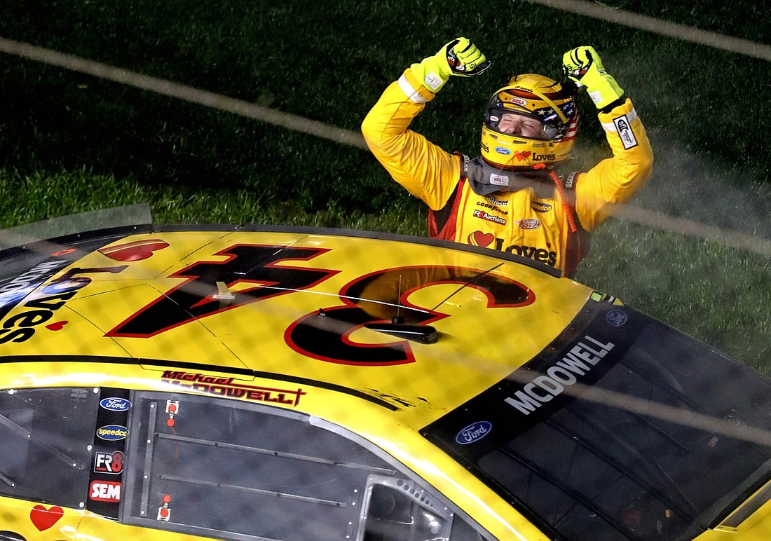 Feb 14, 2021; Daytona Beach, Florida, USA; NASCAR Cup Series driver Michael McDowell (34) celebrates winning the Daytona 500 at Daytona International Speedway. Mandatory Credit: Mark J. Rebilas-USA TODAY Sports