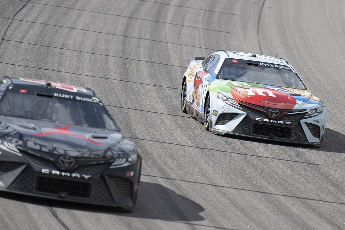 May 15, 2022; Kansas City, Kansas, USA; NASCAR Cup Series driver Kurt Busch (45) and NASCAR Cup Series driver Kyle Busch (18) race during the AdventHealth 400 at Kansas Speedway. Mandatory Credit: Amy Kontras-USA TODAY Sports