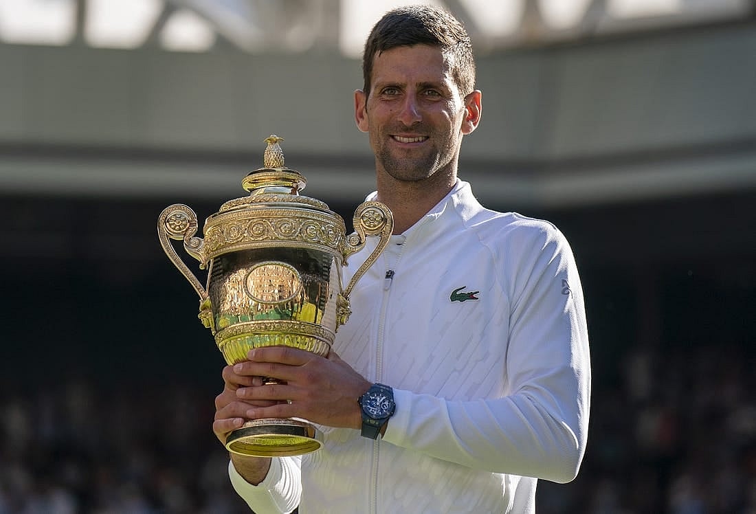 Jul 10, 2022; London, United Kingdom; Novak Djokovic (SRB) poses with the trophy after winning the men   s final against Nick Kyrgios (not pictured) on day 14 at All England Lawn Tennis and Croquet Club. Mandatory Credit: Susan Mullane-USA TODAY Sports