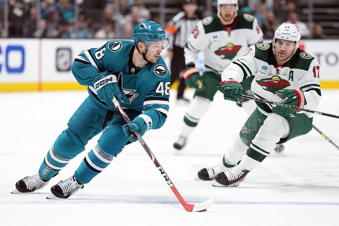 Mar 11, 2023; San Jose, California, USA; San Jose Sharks center Tomas Hertl (48) skates with the puck against Minnesota Wild left wing Marcus Foligno (17) during the second period at SAP Center at San Jose. Mandatory Credit: Darren Yamashita-USA TODAY Sports