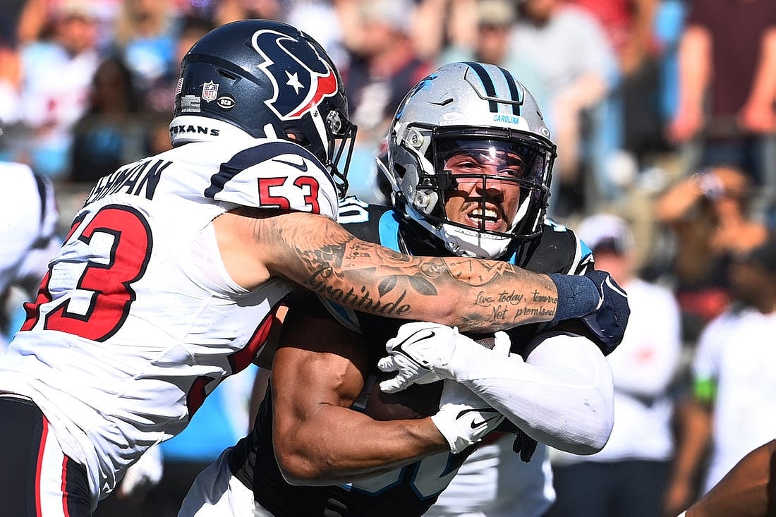 Oct 29, 2023; Charlotte, North Carolina, USA; Carolina Panthers running back Chuba Hubbard (30) with the ball as Houston Texans linebacker Blake Cashman (53) defends in the second quarter at Bank of America Stadium. Mandatory Credit: Bob Donnan-USA TODAY Sports