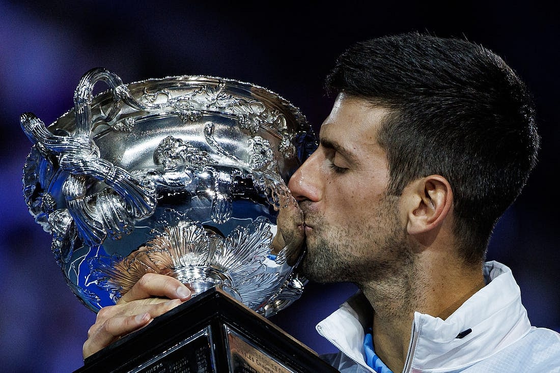 Jan 29, 2023; Melbourne, Victoria, Australia; Novak Djokovic of Serbia celebrates with the trophy after his victory over Stefanos Tsitsipas of Greece in the men
