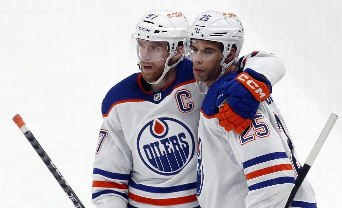 Mar 10, 2024; Pittsburgh, Pennsylvania, USA; Edmonton Oilers center Connor McDavid (left) congratulates defenseman Darnell Nurse (25) after Nurse scored a goal against the Pittsburgh Penguins during the third period at PPG Paints Arena. The Oilers won 4-0. Mandatory Credit: Charles LeClaire-USA TODAY Sports