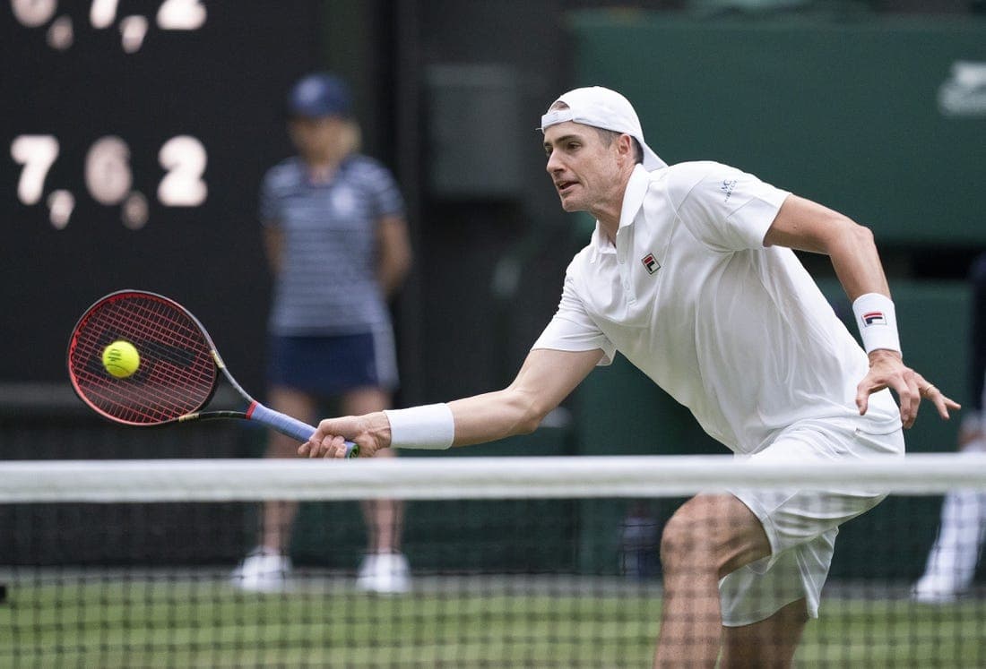 Jun 29, 2022; London, United Kingdom; John Isner (USA) returns a shot during his second round match against Andy Murray (GBR) on day three at All England Lawn Tennis and Croquet Club. Mandatory Credit: Susan Mullane-USA TODAY Sports

