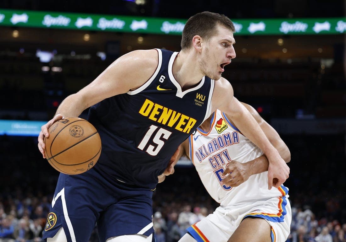 Nov 23, 2022; Oklahoma City, Oklahoma, USA; Denver Nuggets center Nikola Jokic (15) drives to the basket against Oklahoma City Thunder forward Darius Bazley (55) during the second quarter at Paycom Center. Mandatory Credit: Alonzo Adams-USA TODAY Sports