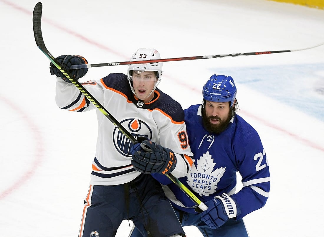 Jan 20, 2021; Toronto, Ontario, CAN;  Toronto Maple Leafs defenseman Zach Bogosian (22) covers Edmonton Oilers forward Ryan Nugent-Hopkins (93) in the third period at Scotiabank Arena. Mandatory Credit: Dan Hamilton-USA TODAY Sports