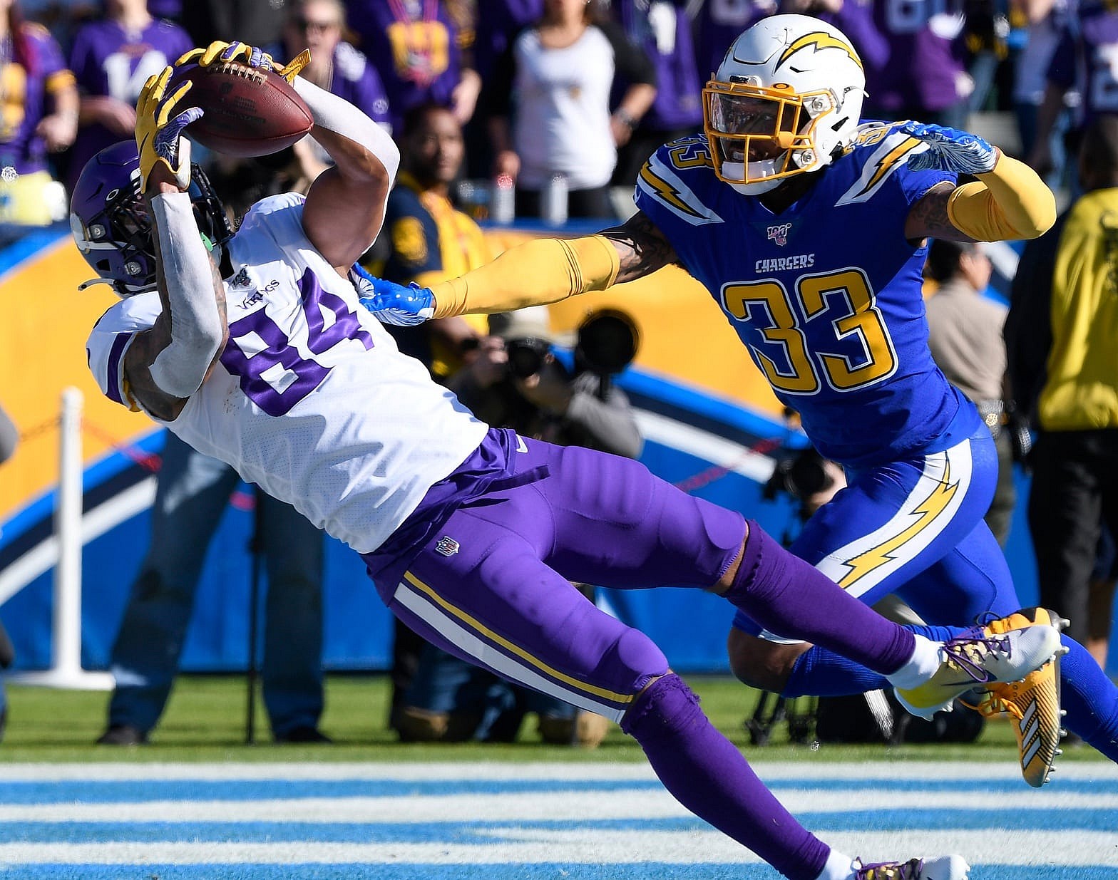 Dec 15, 2019; Carson, CA, USA; Minnesota Vikings tight end Irv Smith (84) makes a diving catch for a touchdown past Los Angeles Chargers free safety Derwin James (33) in the first quarter at Dignity Health Sports Park. Mandatory Credit: Robert Hanashiro-USA TODAY Sports
