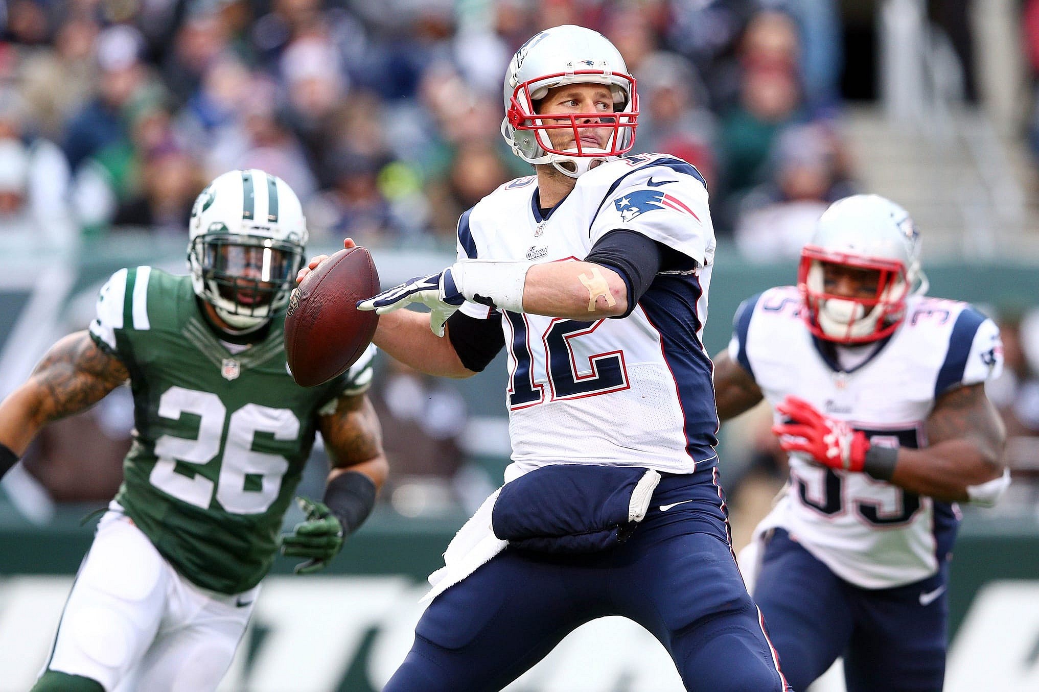  Dec 21, 2014; East Rutherford, NJ, USA; New England Patriots quarterback Tom Brady (12) drops back to pass against the New York Jets during the first quarter at MetLife Stadium. Mandatory Credit: Brad Penner-USA TODAY Sports