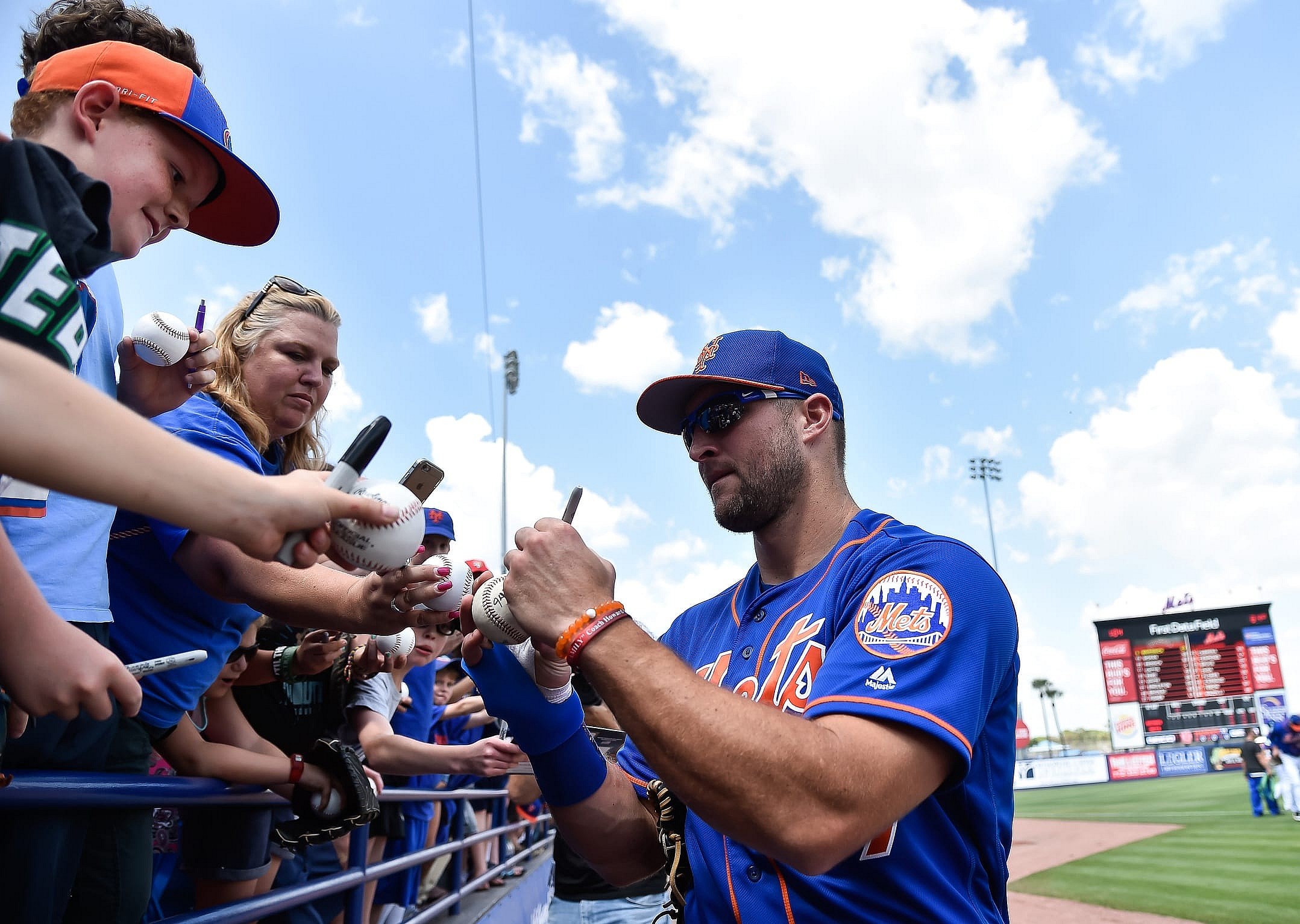 Mar 10, 2017; Port St. Lucie, FL, USA; New York Mets right fielder Tim Tebow (97) signs autographs before a spring training game against the Houston Astros at Tradition Field. Mandatory Credit: Steve Mitchell-USA TODAY Sports