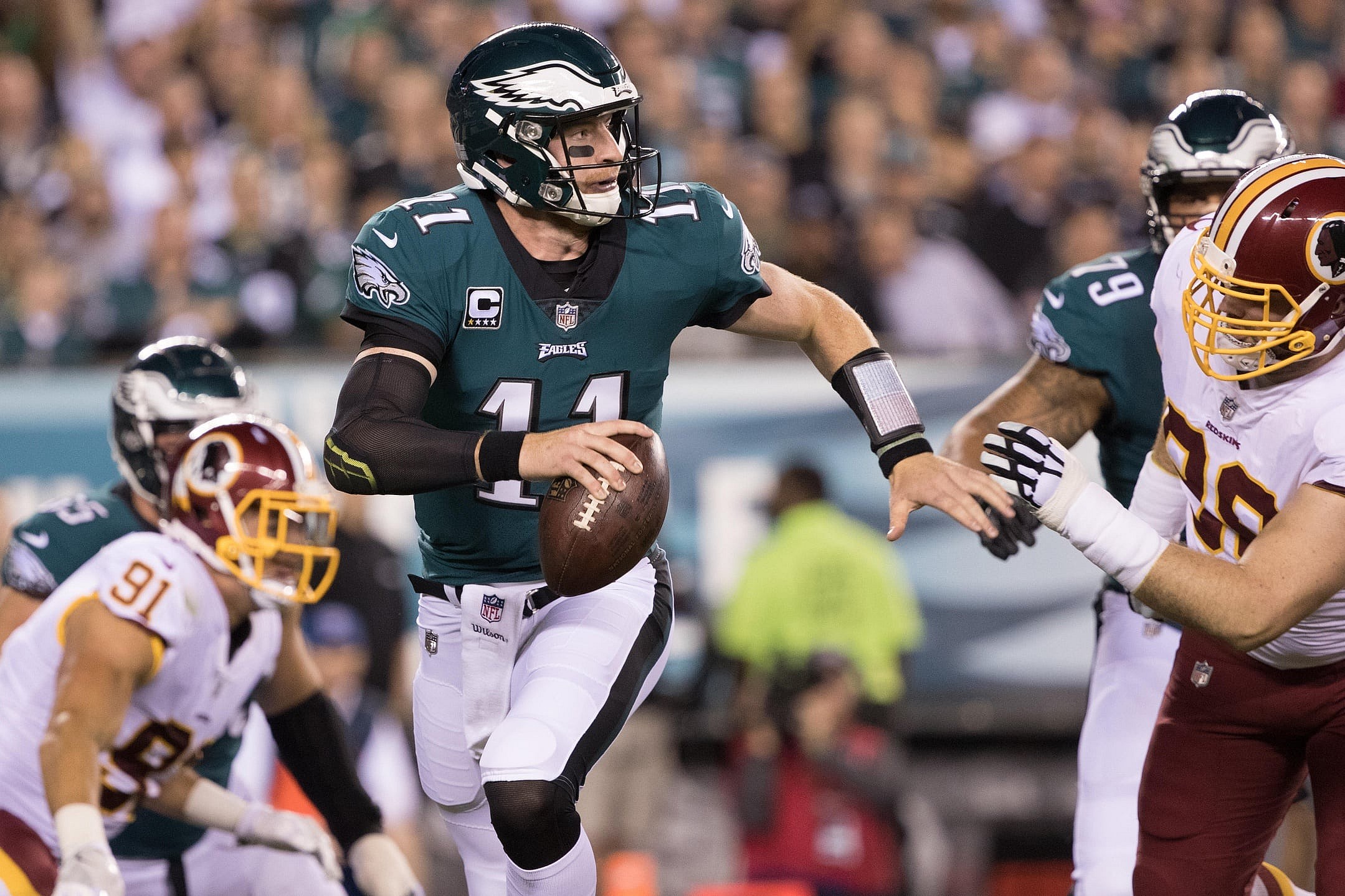 NFL Philadelphia Eagles quarterback Carson Wentz (11) runs out of the pocket past Washington Redskins defensive tackle Matthew Ioannidis (98) during the first quarter at Lincoln Financial Field.