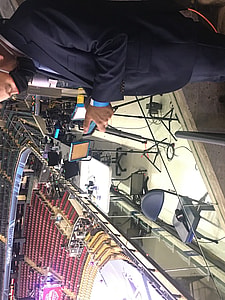 A member of the media looks at their phone.