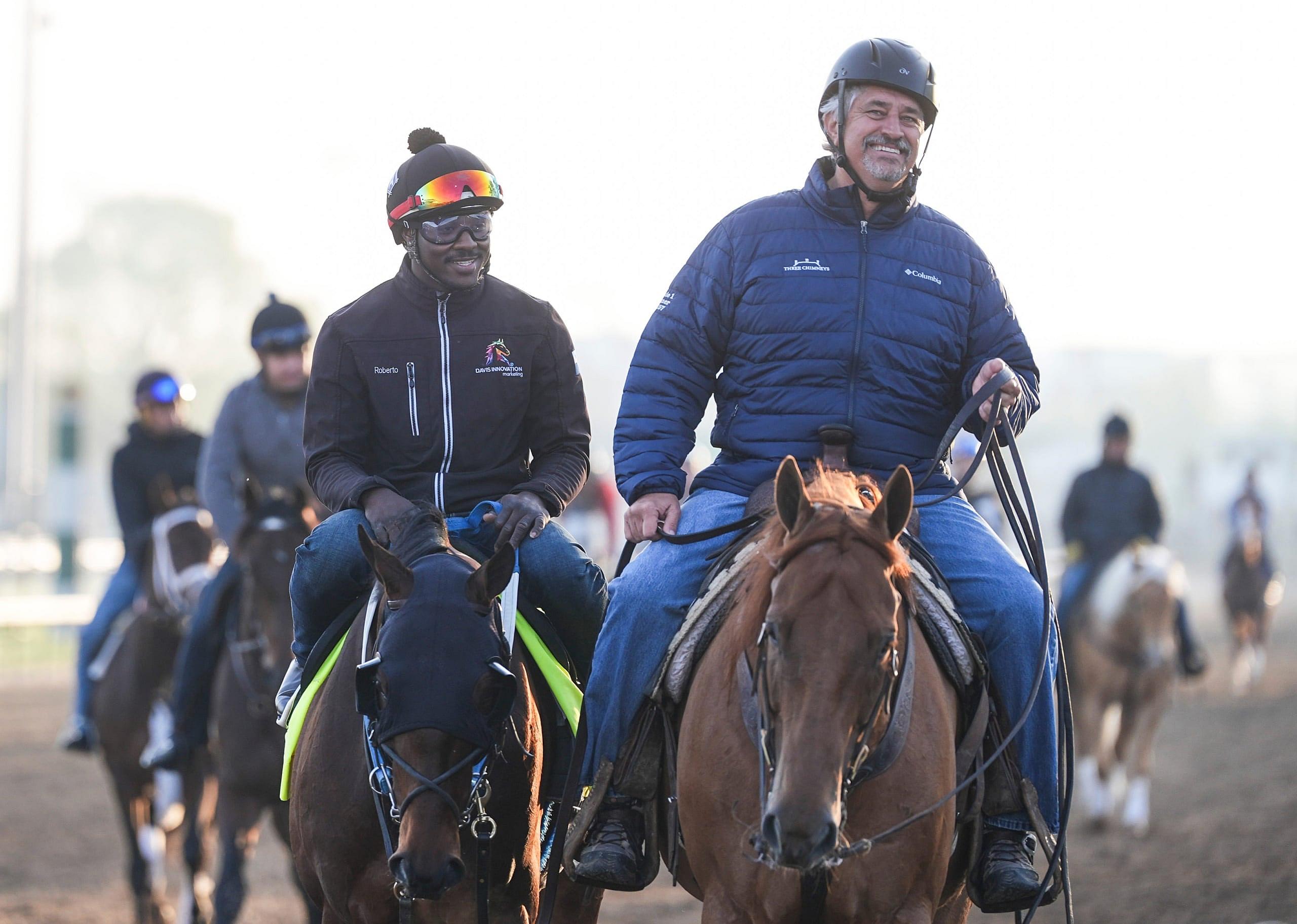 Trainer Steve Asmussen, right, help leads Kentucky Derby 151 contender Publisher after a workout at Churchill Downs in