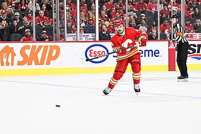 CALGARY, AB - OCTOBER 18: Calgary Flames Defenceman Rasmus Andersson (4) passes the puck during the second period of an NHL game between the Calgary Flames and the Vegas Golden Knights on October 18, 2022, at the Scotiabank Saddledome in Calgary, AB. (Photo by Brett Holmes/Icon Sportswire)