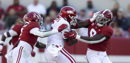 Nov 20, 2021; Tuscaloosa, Alabama, USA;  Arkansas running back Raheim Sanders (5) attempts to break a tackle by Alabama defensive back DeMarcco Hellams (2) and Alabama linebacker Christian Harris (8) at Bryant-Denny Stadium. Mandatory Credit: Gary Cosby Jr.-USA TODAY Sports