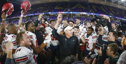 Dec 21, 2019; Orlando, Florida, USA; Liberty Flames head coach Hugh Freeze (middle) celebrates with his team after winning the Cure Bowl  against Georgia the Southern Eagles at Exploria Stadium. Mandatory Credit: Reinhold Matay-USA TODAY Sports