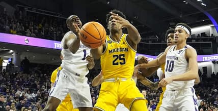 Feb 2, 2023; Evanston, Illinois, USA; Northwestern Wildcats guard Chase Audige (1) defends Michigan Wolverines guard Jace Howard (25) during the first half at Welsh-Ryan Arena. Mandatory Credit: David Banks-USA TODAY Sports