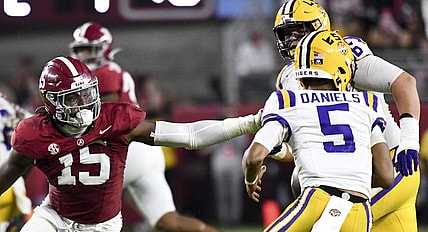 Nov 4, 2023; Tuscaloosa, Alabama, USA;  LSU Tigers quarterback Jayden Daniels (5) escapes the pass rush of Alabama Crimson Tide linebacker Dallas Turner (15) at Bryant-Denny Stadium. Alabama defeated LSU 42-28. Mandatory Credit: Gary Cosby Jr.-USA TODAY Sports