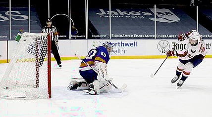 Apr 22, 2021; Uniondale, New York, USA; Washington Capitals center Evgeny Kuznetsov (92) scores the game deciding goal against New York Islanders goaltender Semyon Varlamov (40) during the shootout at Nassau Veterans Memorial Coliseum. Mandatory Credit: Andy Marlin-USA TODAY Sports