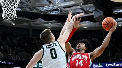 Mar 4, 2023; East Lansing, Michigan, USA;  Ohio State Buckeyes forward Justice Sueing (14) shoots against Michigan State Spartans forward Jaxon Kohler (0) in the first half at Jack Breslin Student Events Center. Mandatory Credit: Dale Young-USA TODAY Sports