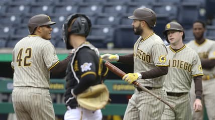 Apr 15, 2021; Pittsburgh, Pennsylvania, USA;  San Diego Padres third baseman Manny Machado (left) is congratulated by San Diego Padres first baseman Eric Hosmer (30) after hitting a two run home run as Pittsburgh Pirates catcher Jacob Stallings (middle) looks on during the first inning at PNC Park. Mandatory Credit: Charles LeClaire-USA TODAY Sports