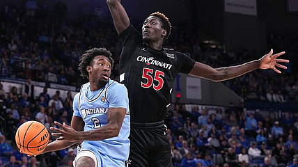 Indiana State Sycamores guard Isaiah Swope (2) goes in to pass the ball against Cincinnati Bearcats forward Aziz Bandaogo (55) on Tuesday, March 26, 2024, during the quarterfinals of the NIT at the Hulman Center in Terre Haute.