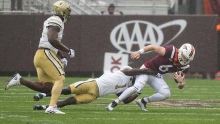 Nov 5, 2022; Blacksburg, Virginia, USA; Virginia Tech Hokies quarterback Grant Wells (6) gets tackled by Georgia Tech Yellow Jackets linebacker Charlie Thomas (1 at )Lane Stadium in the first half. Mandatory Credit: Lee Luther Jr.-USA TODAY Sports