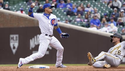May 8, 2021; Chicago, Illinois, USA; Chicago Cubs shortstop Javier Baez (9) forces out Pittsburgh Pirates second baseman Adam Frazier (26) at second base during the third inning at Wrigley Field. Mandatory Credit: David Banks-USA TODAY Sports