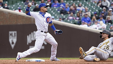 May 8, 2021; Chicago, Illinois, USA; Chicago Cubs shortstop Javier Baez (9) forces out Pittsburgh Pirates second baseman Adam Frazier (26) at second base during the third inning at Wrigley Field. Mandatory Credit: David Banks-USA TODAY Sports