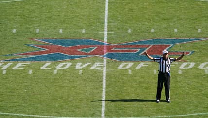 Feb 16, 2020; Carson, California, USA; XFL referee Reggie Smith gestures with the XFL logo as backdrop in the first quarter of the game between the LA Wildcats and the Dallas Renegades at Dignity Health Sports Park.  Mandatory Credit: Kirby Lee-USA TODAY Sports