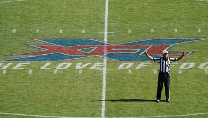 Feb 16, 2020; Carson, California, USA; XFL referee Reggie Smith gestures with the XFL logo as backdrop in the first quarter of the game between the LA Wildcats and the Dallas Renegades at Dignity Health Sports Park.  Mandatory Credit: Kirby Lee-USA TODAY Sports
