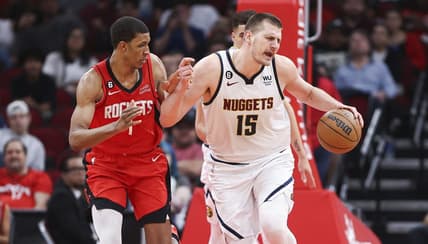 Apr 4, 2023; Houston, Texas, USA; Denver Nuggets center Nikola Jokic (15) dribbles the ball as Houston Rockets forward Jabari Smith Jr. (1) defends during the third quarter at Toyota Center. Mandatory Credit: Troy Taormina-USA TODAY Sports
