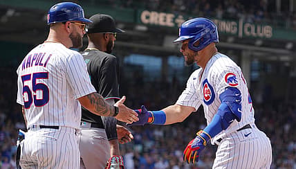 Aug 6, 2022; Chicago, Illinois, USA; Chicago Cubs designated hitter Willson Contreras (40) is greeted by  first base coach Mike Napoli (55) after hitting a one run single against the Miami Marlins during the fifth inning at Wrigley Field. Mandatory Credit: David Banks-USA TODAY Sports