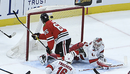 Feb 4, 2021; Chicago, Illinois, USA; Chicago Blackhawks right wing Andrew Shaw (65) scores a goal on Carolina Hurricanes goaltender James Reimer (47) during the first period at United Center. Mandatory Credit: David Banks-USA TODAY Sports