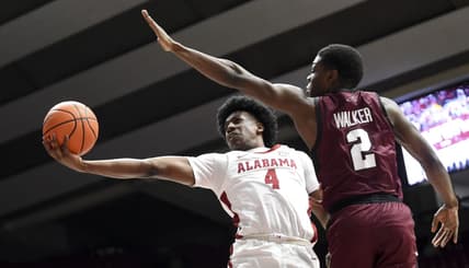 Dec 23, 2023; Tuscaloosa, Alabama, USA;  Alabama guard Davin Cosby Jr. (4) attempts a shot inside with Eastern Kentucky guard Leland Walker (2) defending at Coleman Coliseum. Mandatory Credit: Gary Cosby Jr.-USA TODAY Sports