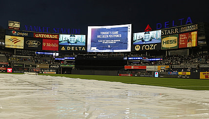 Jul 2, 2021; Bronx, New York, USA; A general view of Yankee Stadium with the tarp on the field and the video board announcing the game between the New York Mets and the New York Yankees has been postponed at Yankee Stadium. Mandatory Credit: Andy Marlin-USA TODAY Sports